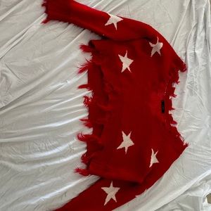 i’m selling a red sweater off the shoulder with white stars on it